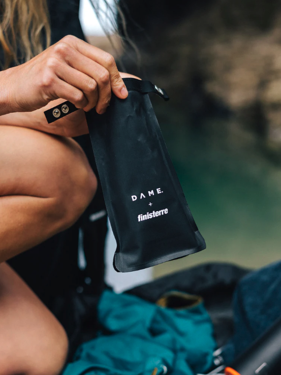 A woman opens a reusable period pad bag.