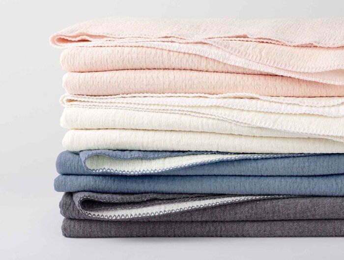 A stack of Coyuchi baby blankets.