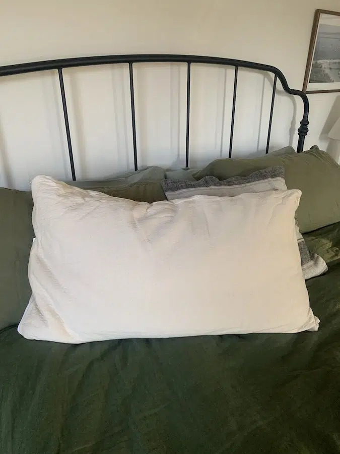 A birch pillow on a bed.