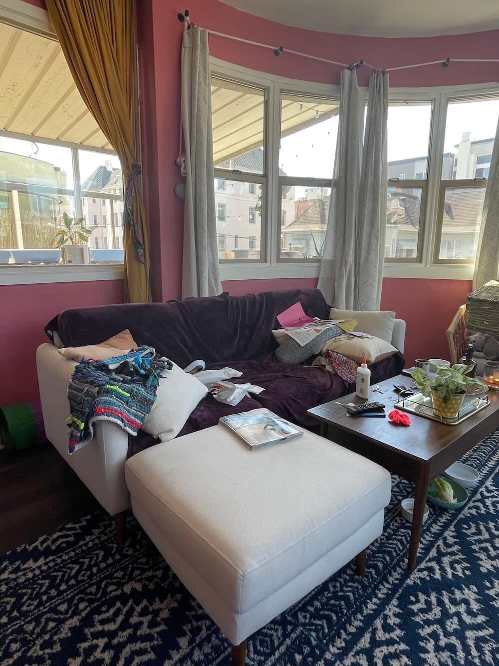 A Burrow couch being used in a pink living room.