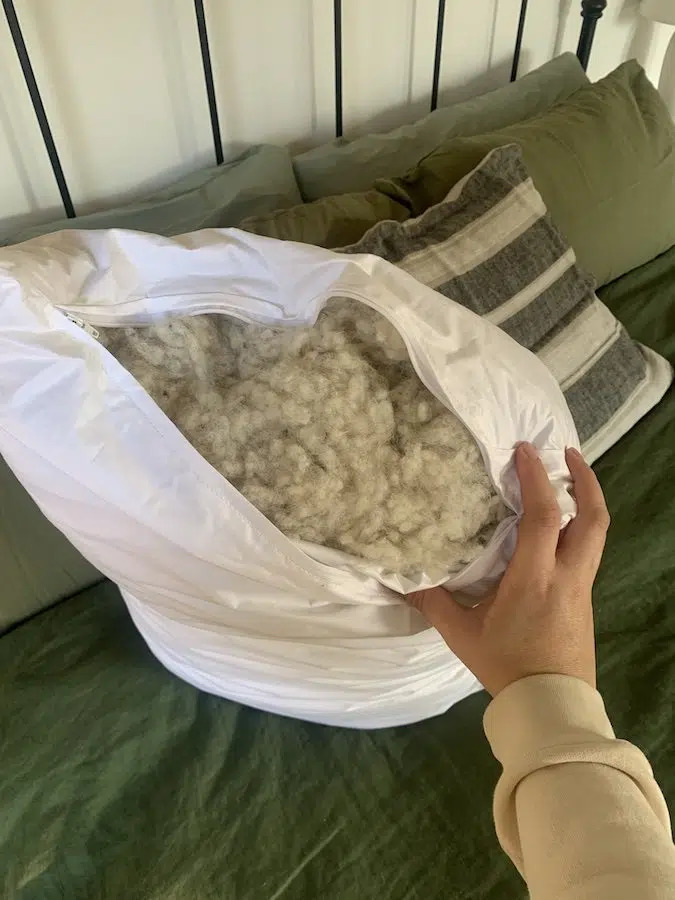 A hand shows the filling of a pillow.