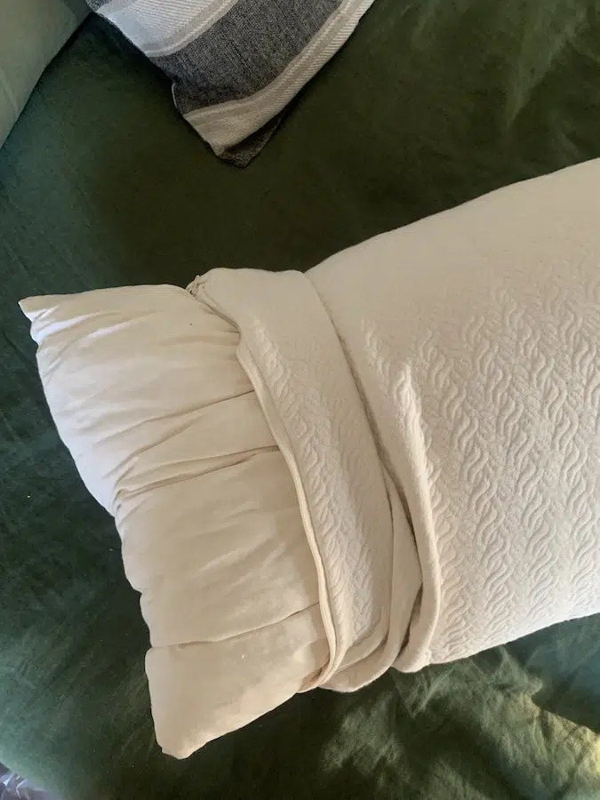The cover partially pulled off to show the pillow beneath.