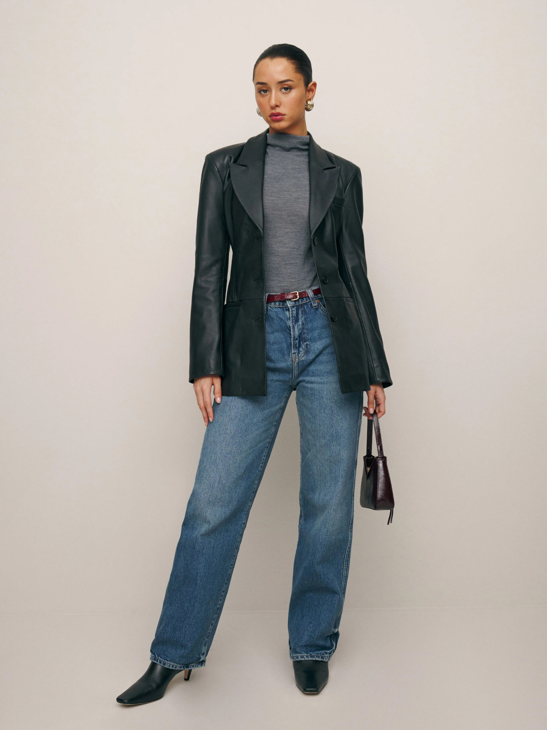 A model wearing a leather blazer from Reformation.