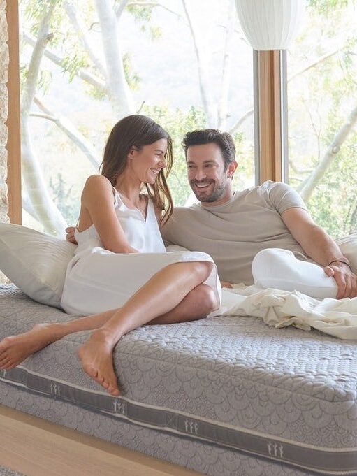 A couple lounges and laughs on their vegan mattress.