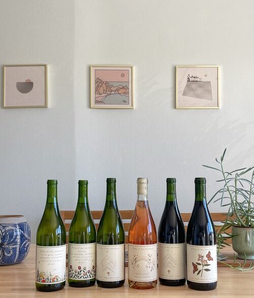 Six bottles on a table. 