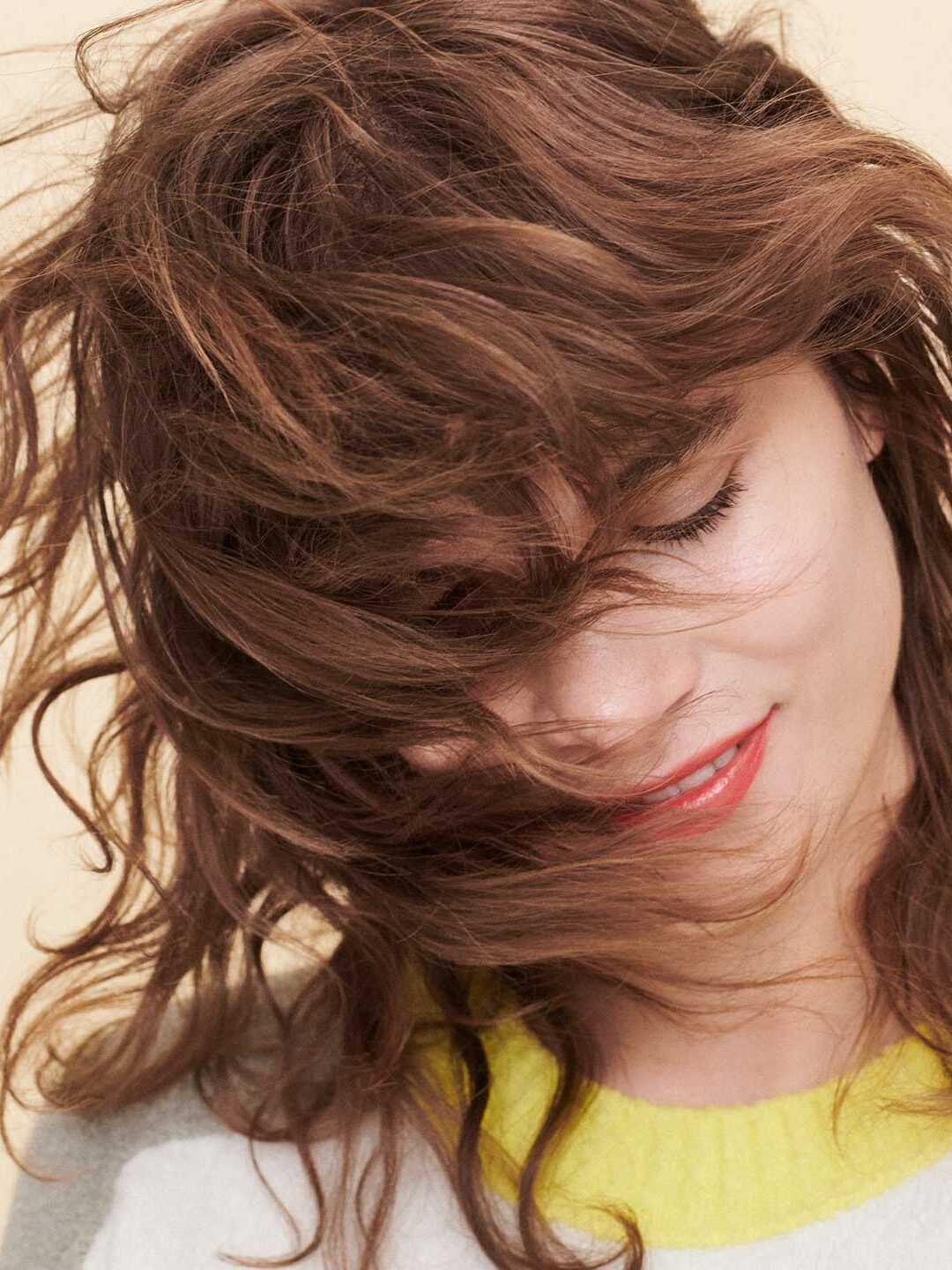 A model with reddish wavy hair. 