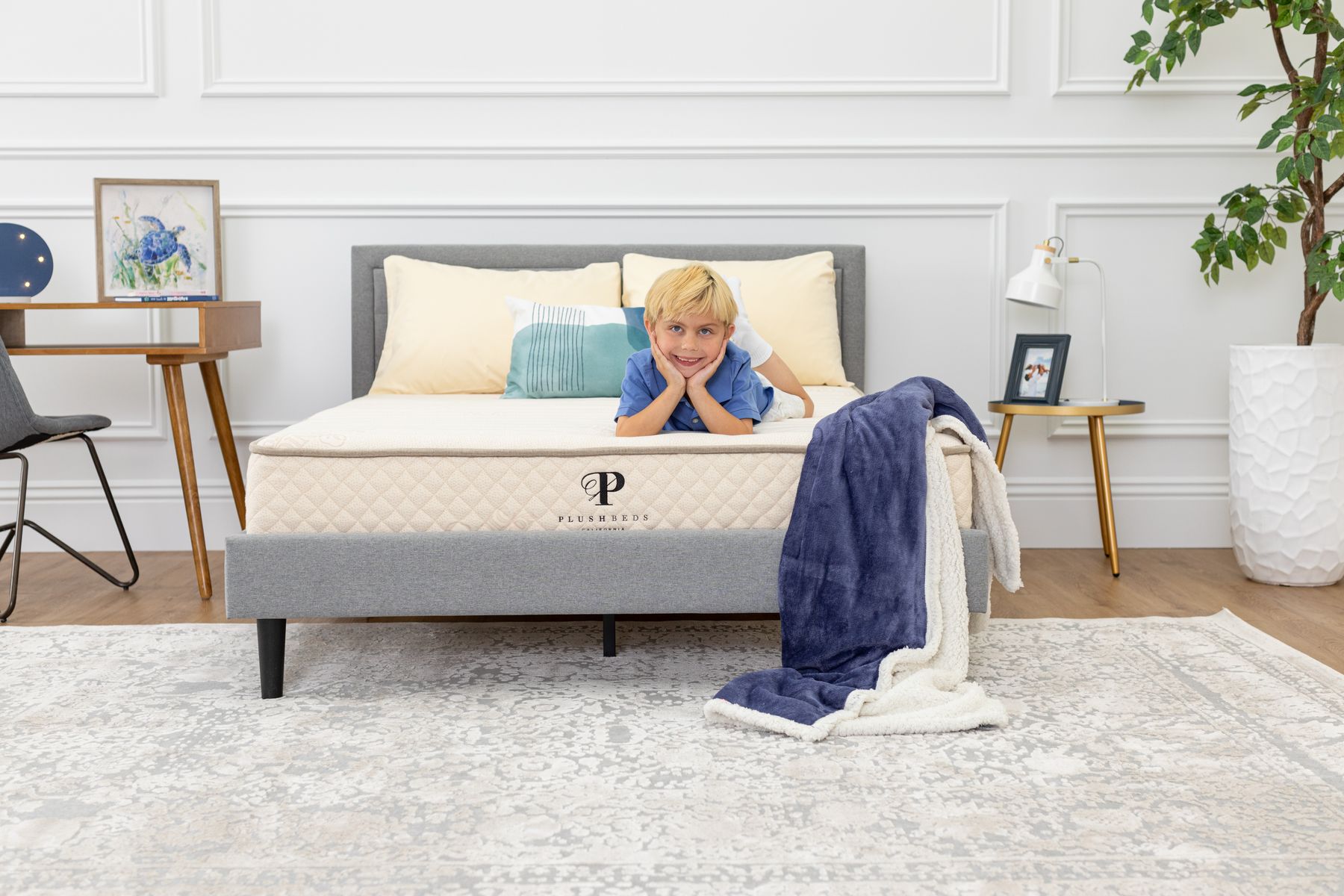 A little boy lies on a natural latex mattress.