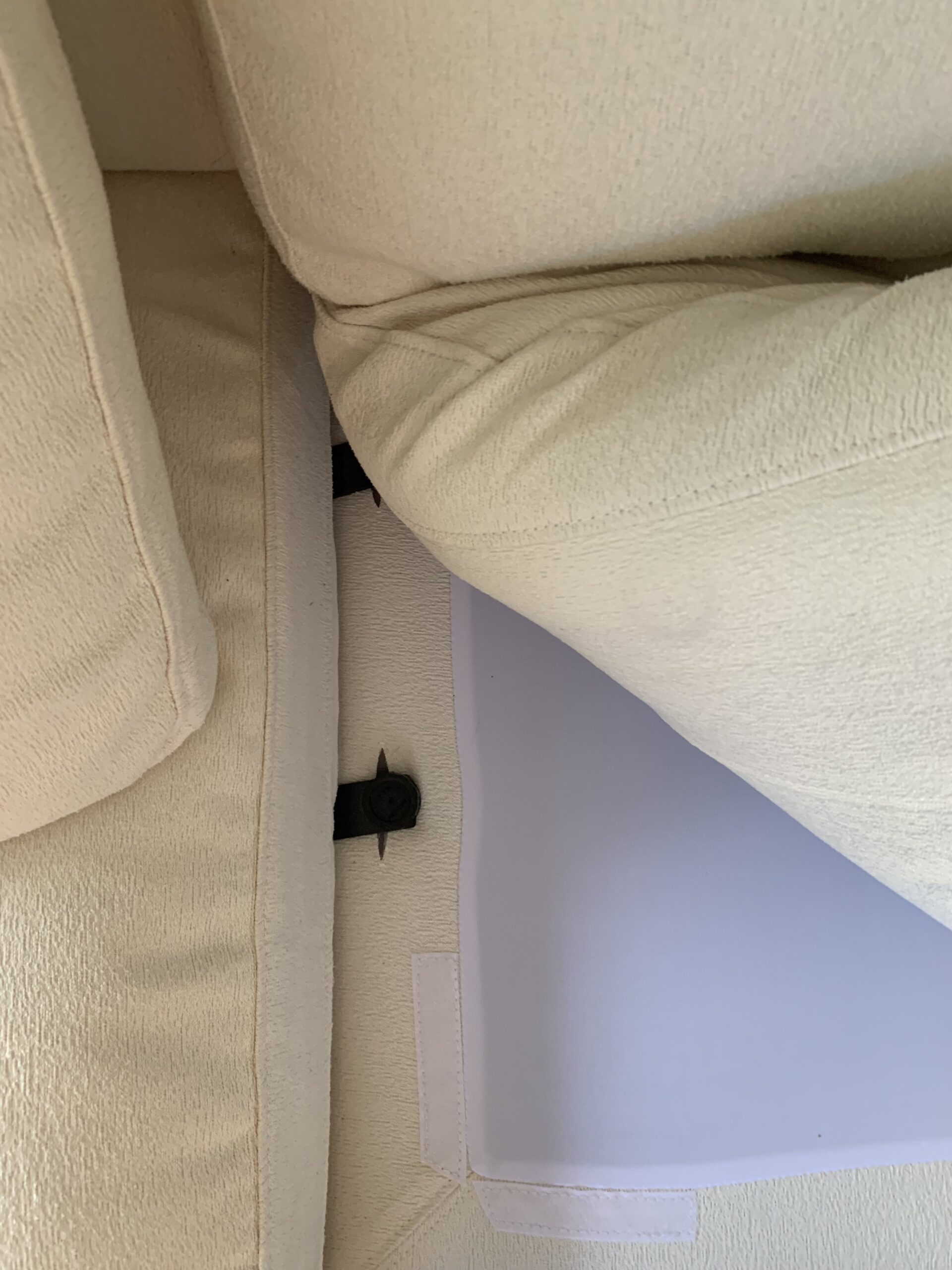 Underneath a 7th avenue couch cushion.