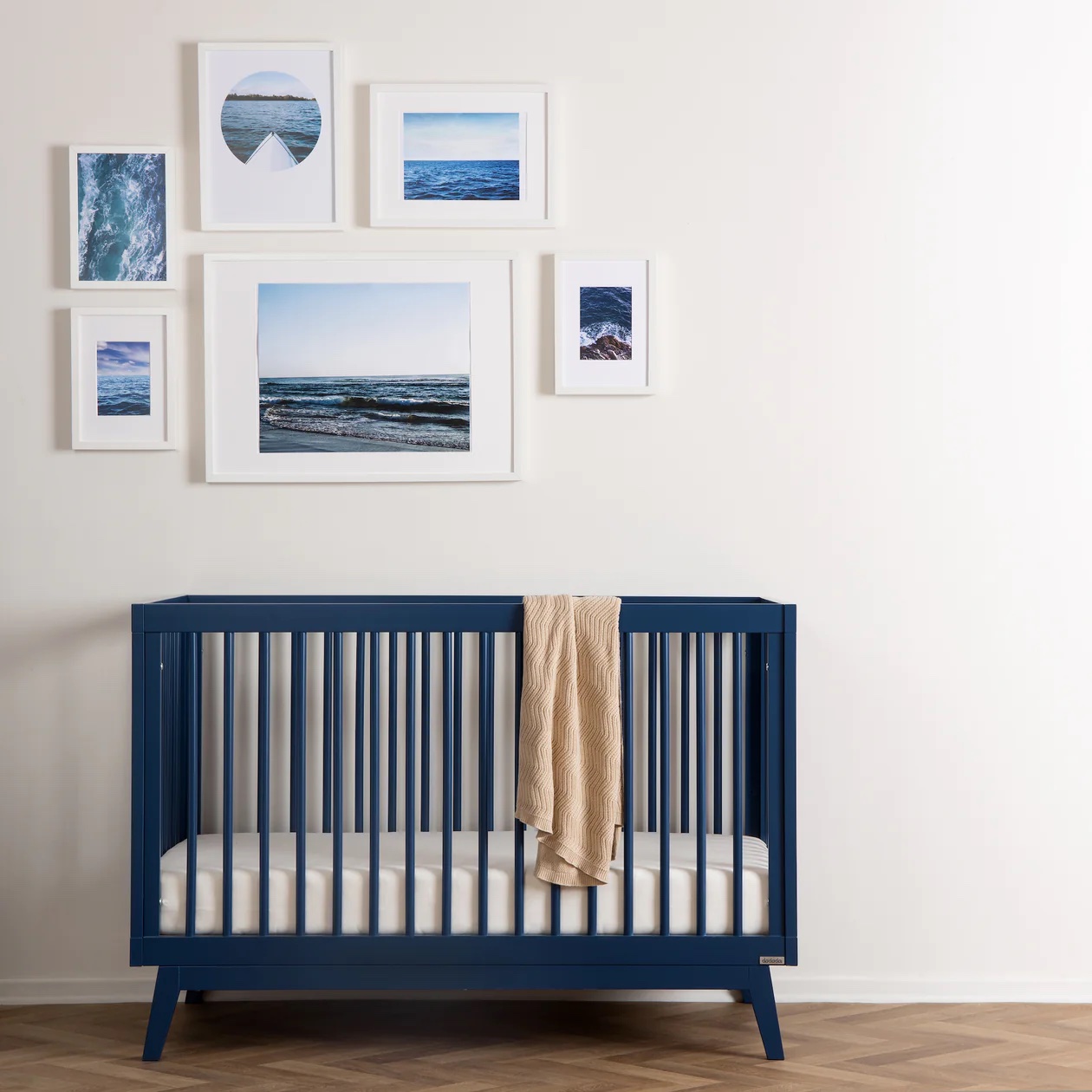 A navy blue wooden crib.