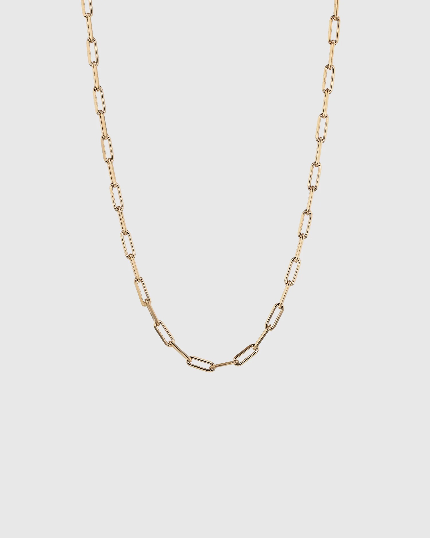 A gold block chain necklace.