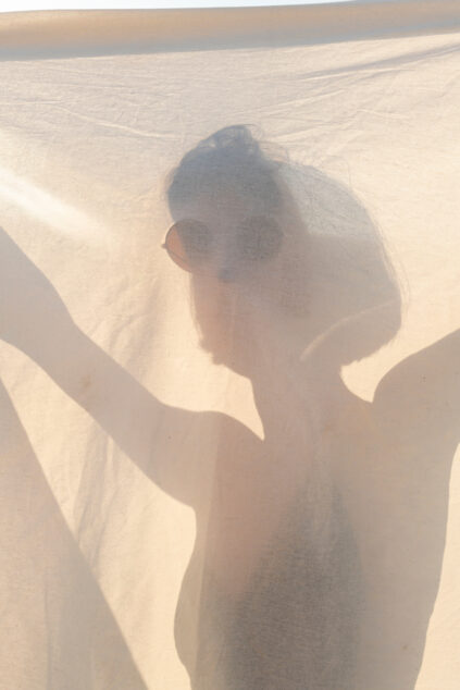 woman holding a white sheet