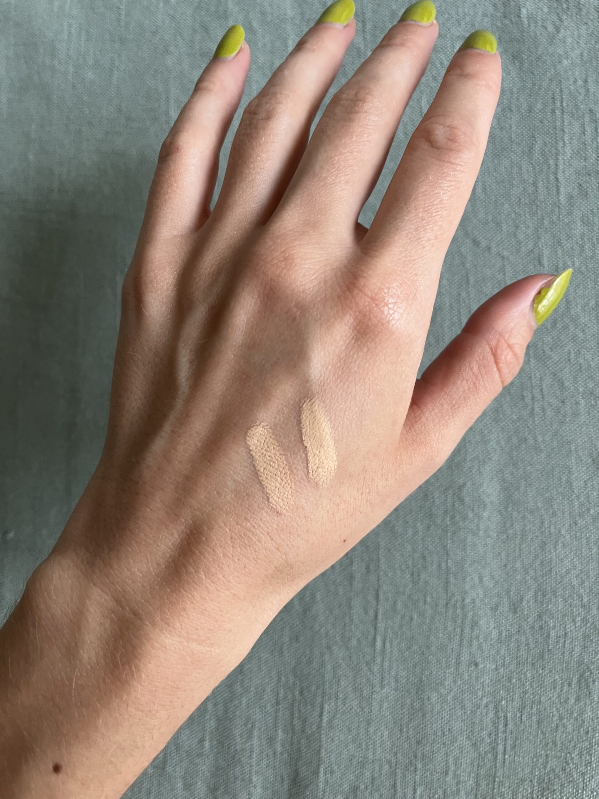 A sample of Merit foundation on the back of a hand.