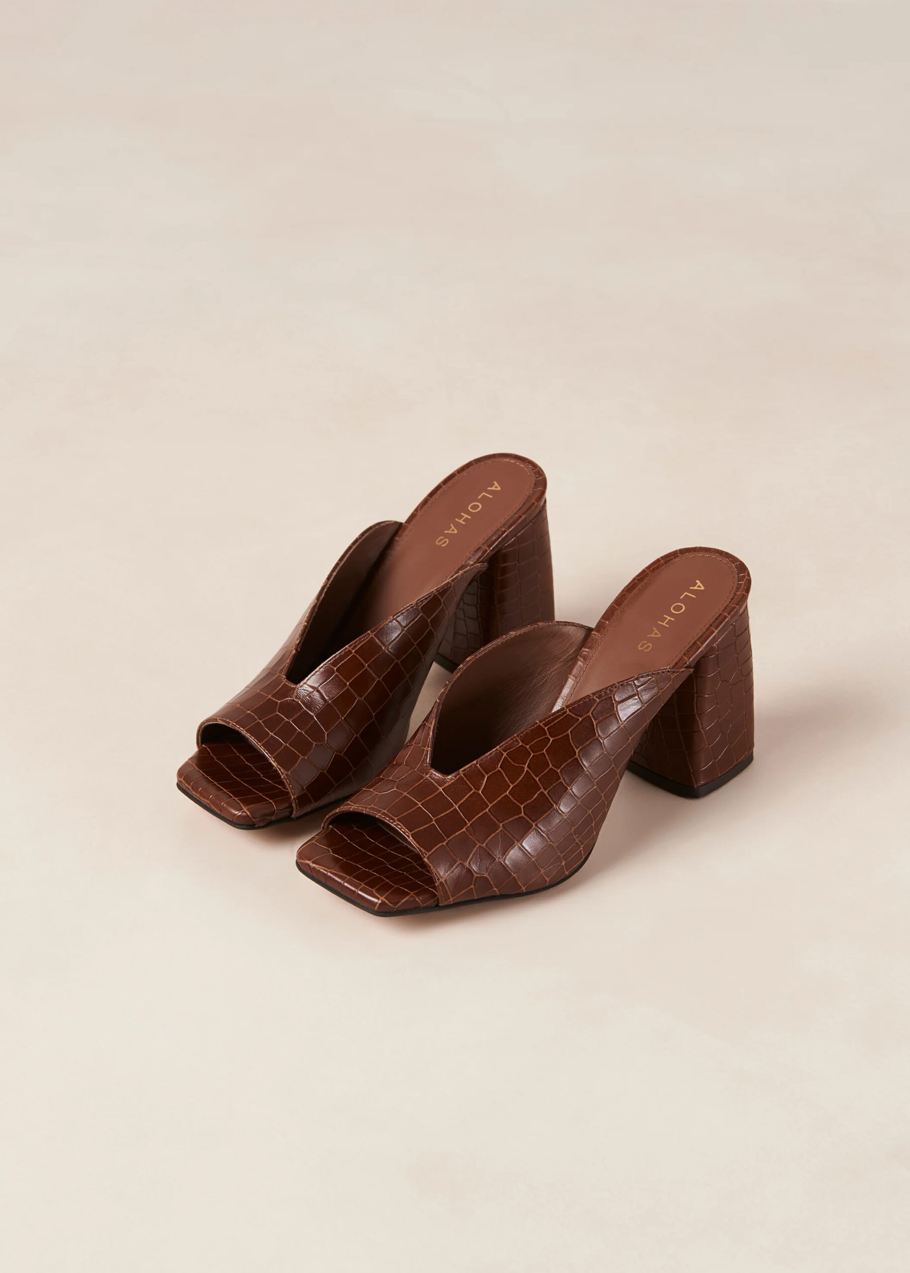 Brown crocodile-textured brown mule heels.