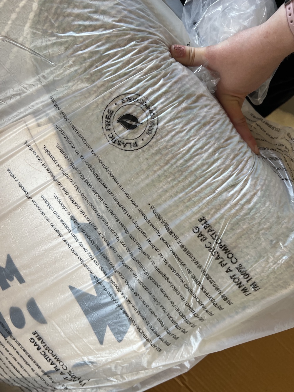 lose up of a Lorena Canals rug encased in compostable packaging. 