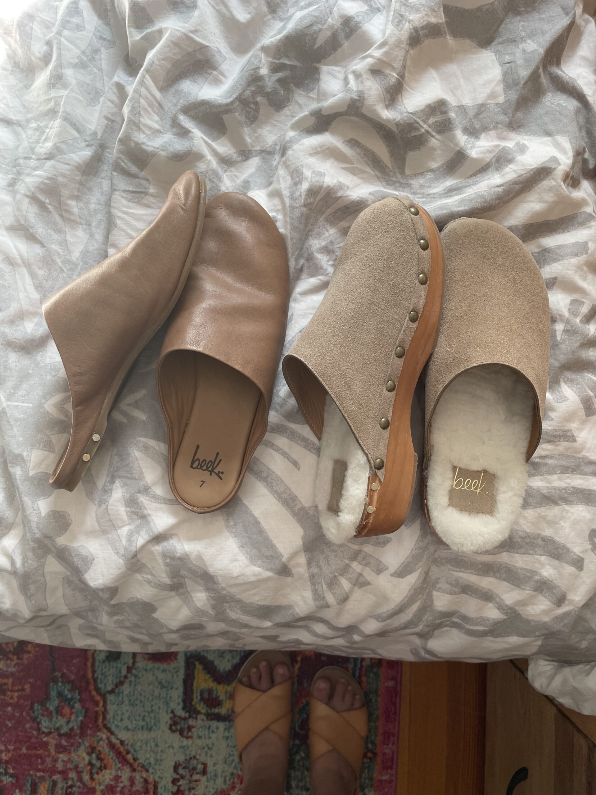 Two pairs of Beek clogs/mules next to each other. 