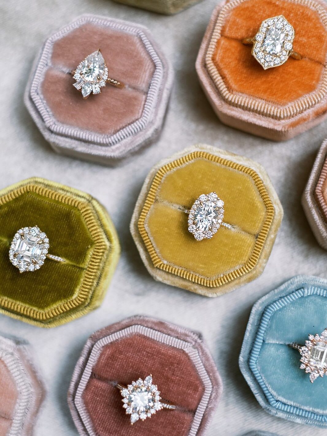 Close up of moissanite rings in velvet antique colored velvet boxes from Kristin Coffin