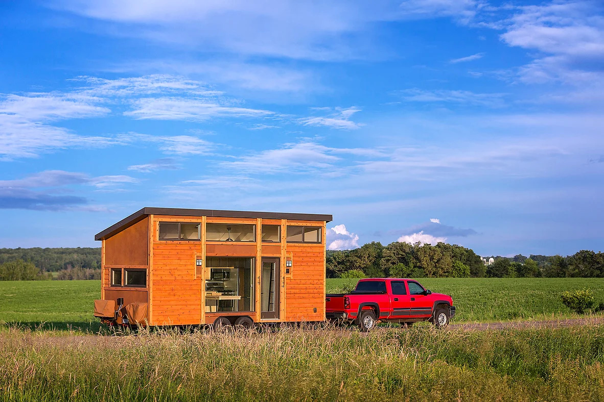An Escape Traveler tiny home being pulled by a truck.