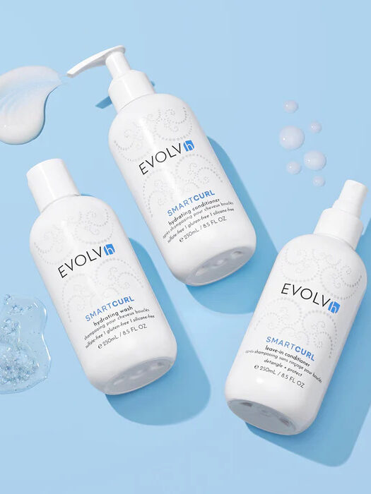 A studio shot of EVOLVh's curly hair trio.