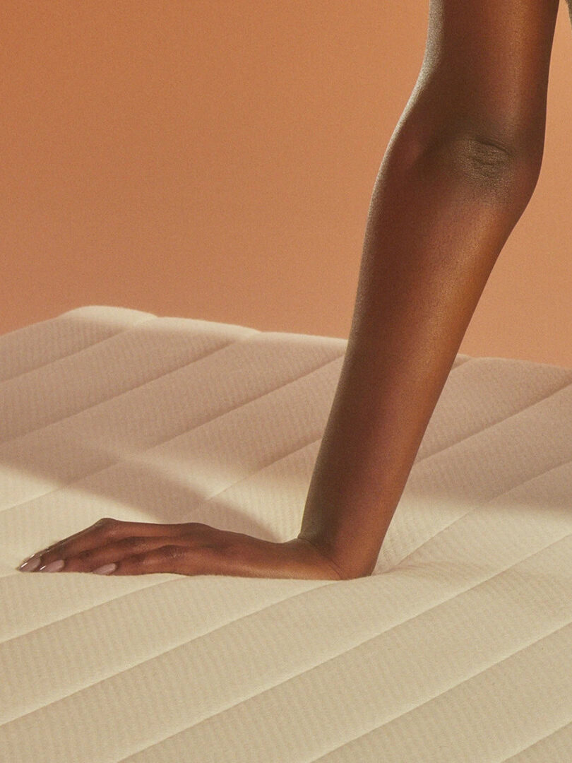 A hand pressing into an Earthfoam mattress.