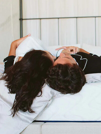 A couple laying down on a Nest mattress.