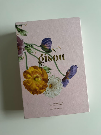 The packaging for the Gisou hair oil.