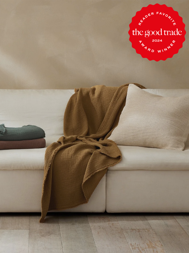 A Coyuchi quilt on a couch. The TGT 2024 Award Winner Badge is on the right corner of the image.