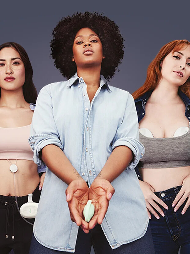 Three models holding and wearing Elvie Breast Pumps.