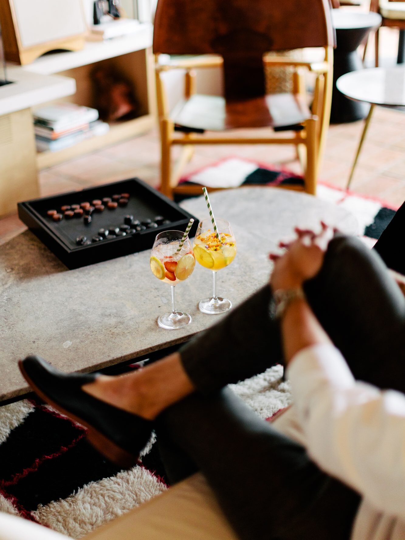 A coffee table with a board game and two glasses of Sangria at Hotel Joaquin.