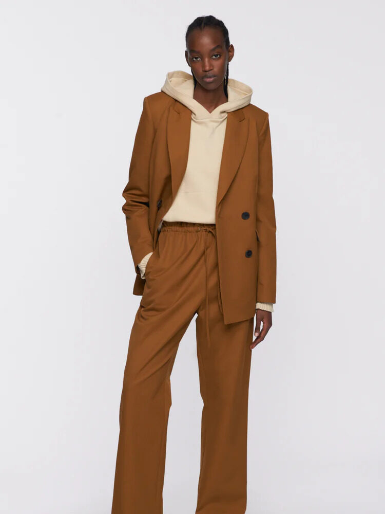 A model wearing the Ochre pantsuit set from Kotn.