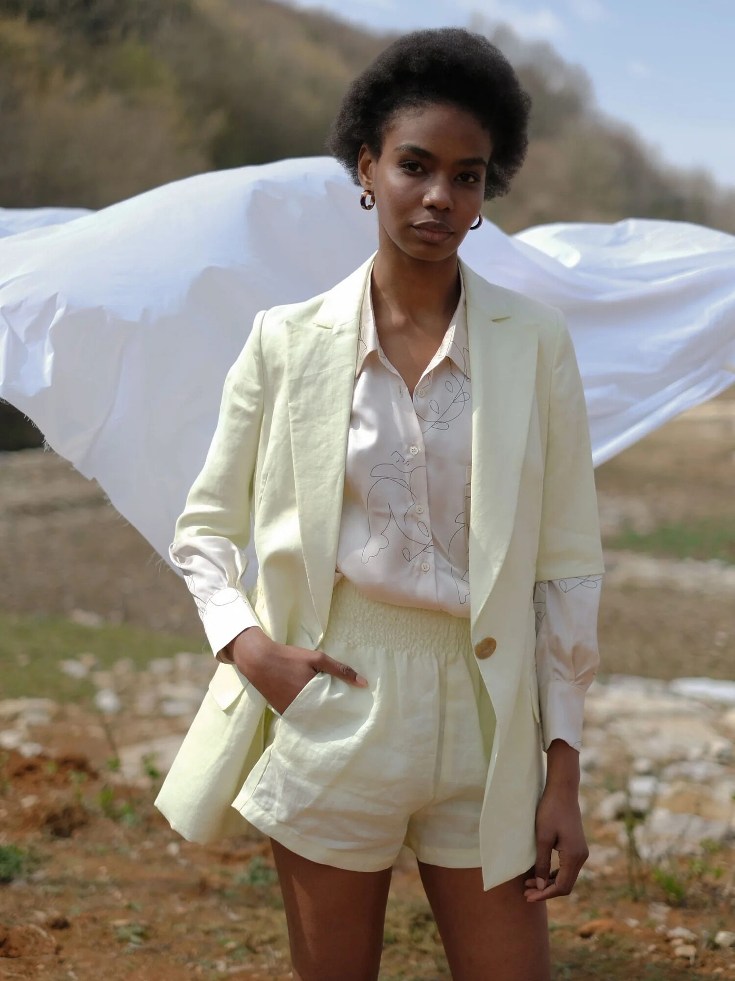 A model wearing a highlighter yellow blazer and shorts set from OhSevenDays.