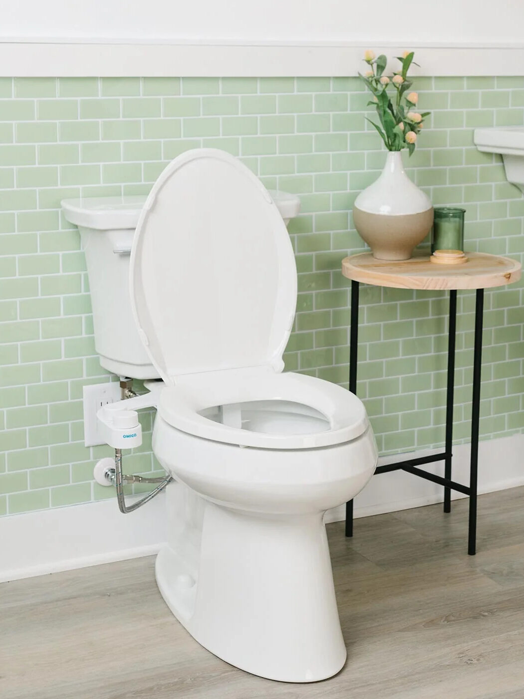 OMIGO bidet on a toilet in a bathroom. 