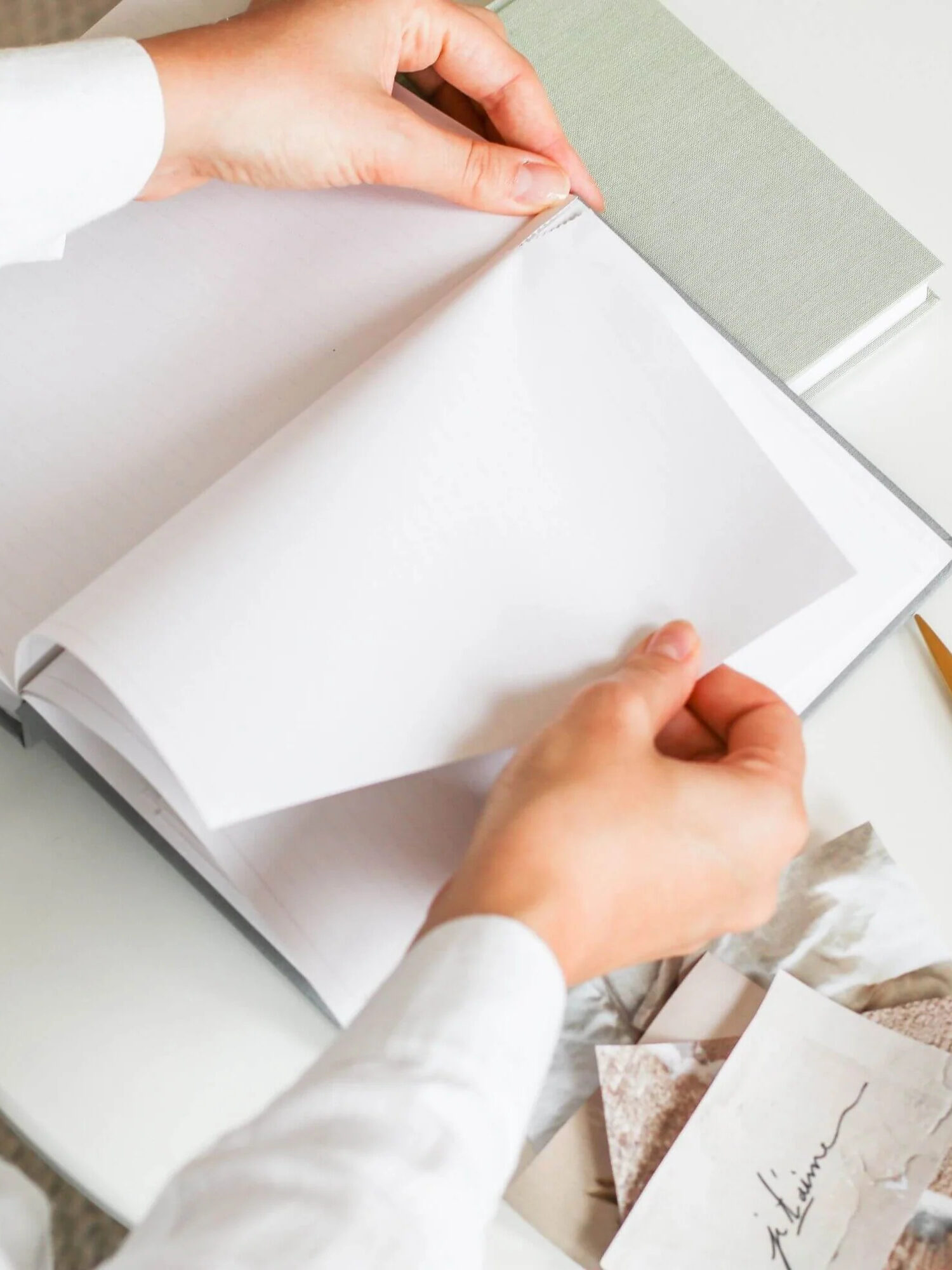 A close up of a sheet from Ponderlily's 2024 planner being torn from its perforation.