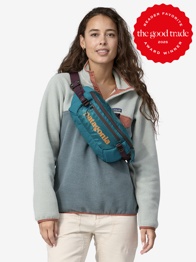 A person wearing a Patagonia fleece and crossbody bag. There's a red badge stating "Reader Favorite" and "The Good Trade Award Winner 2023" in the top right corner.