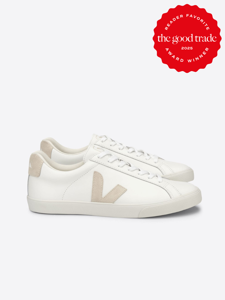 White sneakers with beige accents and a lace-up design, embodying the effortless chic of French girl fashion. A red badge proudly proclaims "Reader Favorite, the good trade, 2025, Award Winner," making these sneakers both stylish and celebrated.