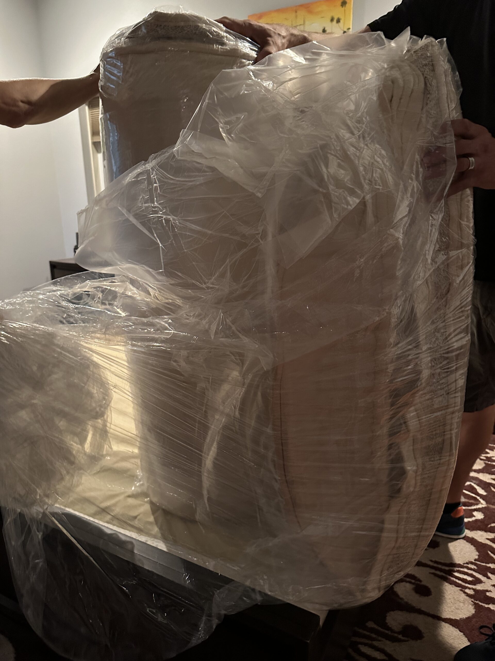 A wrapped up mattress in plastic. 