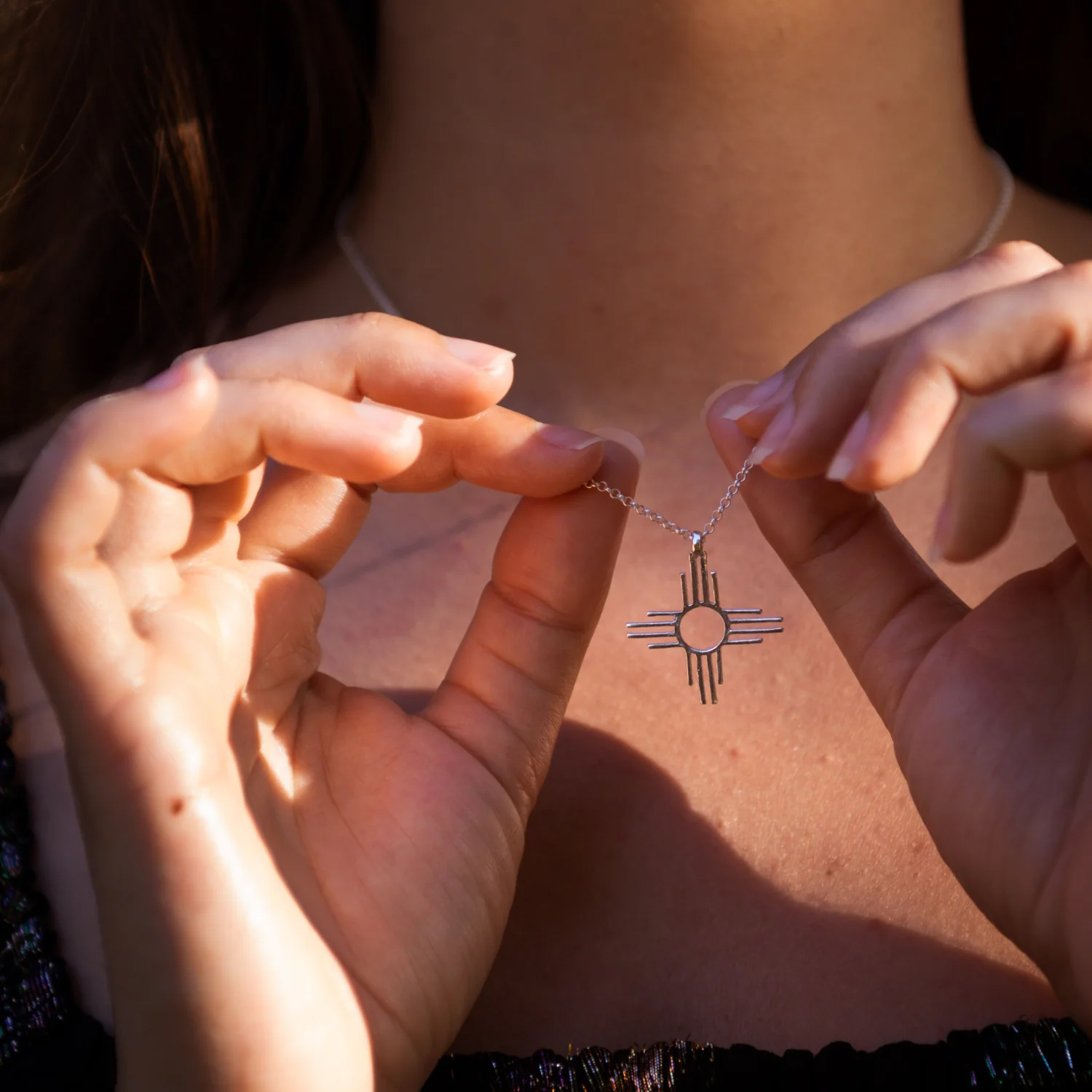 A model holding a neckless up from T Skies