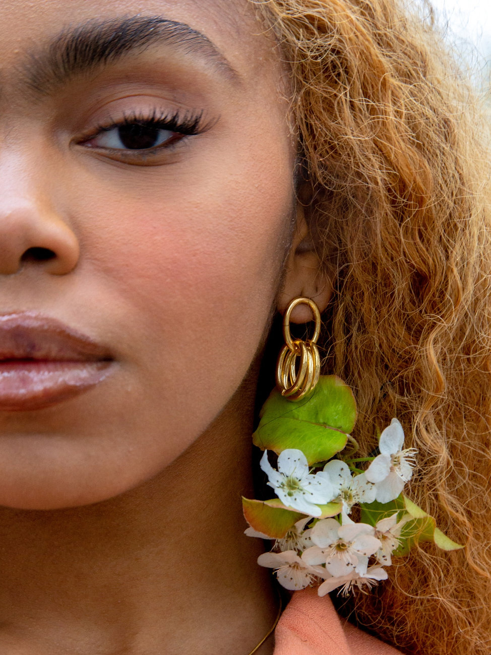 A model wearing earrings from Yam