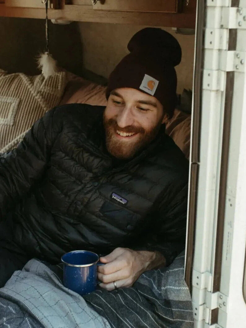 A model laying on a Stumptown Mattress in an RV.