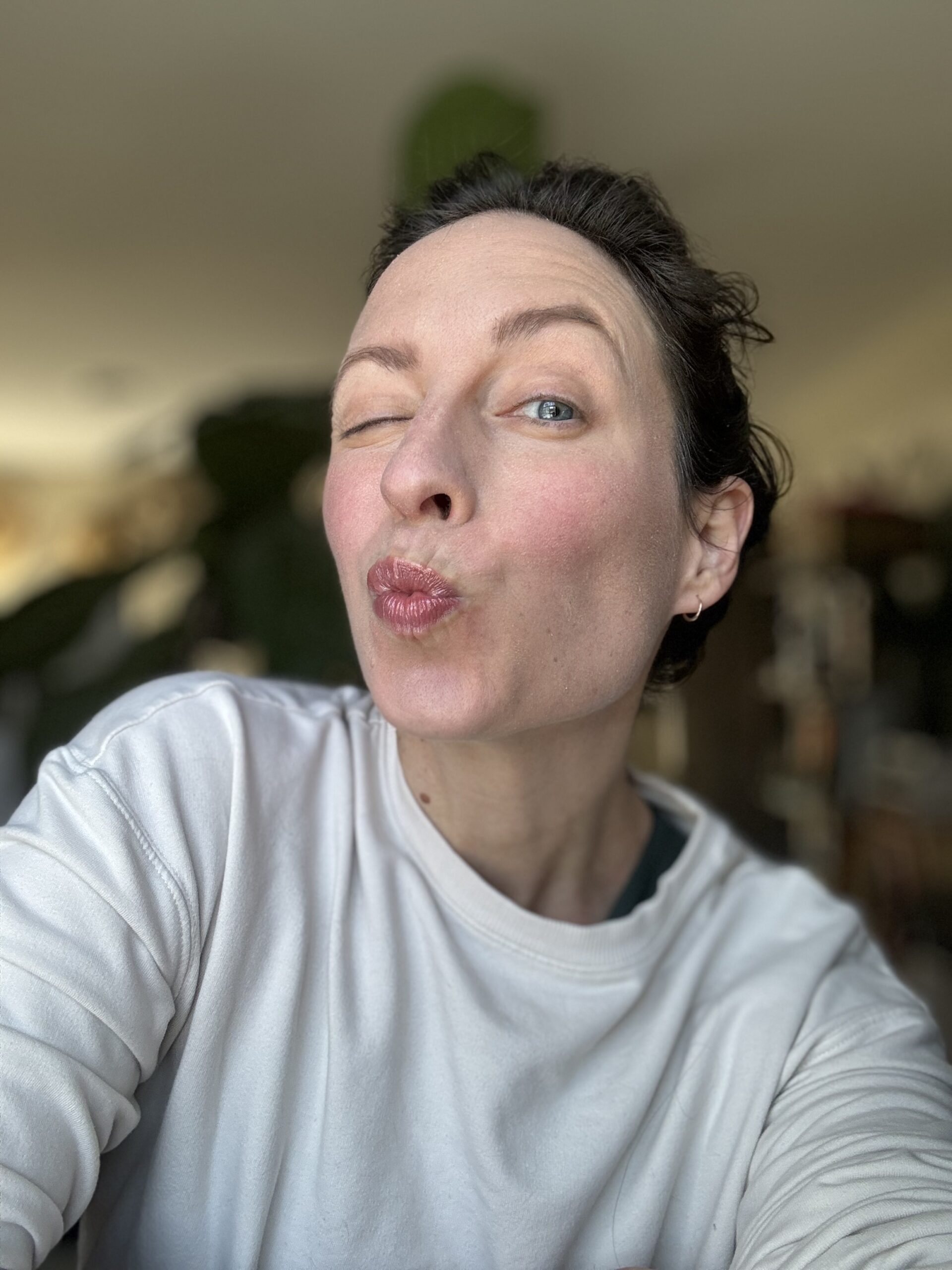 Woman puckering her lips for a playful selfie.