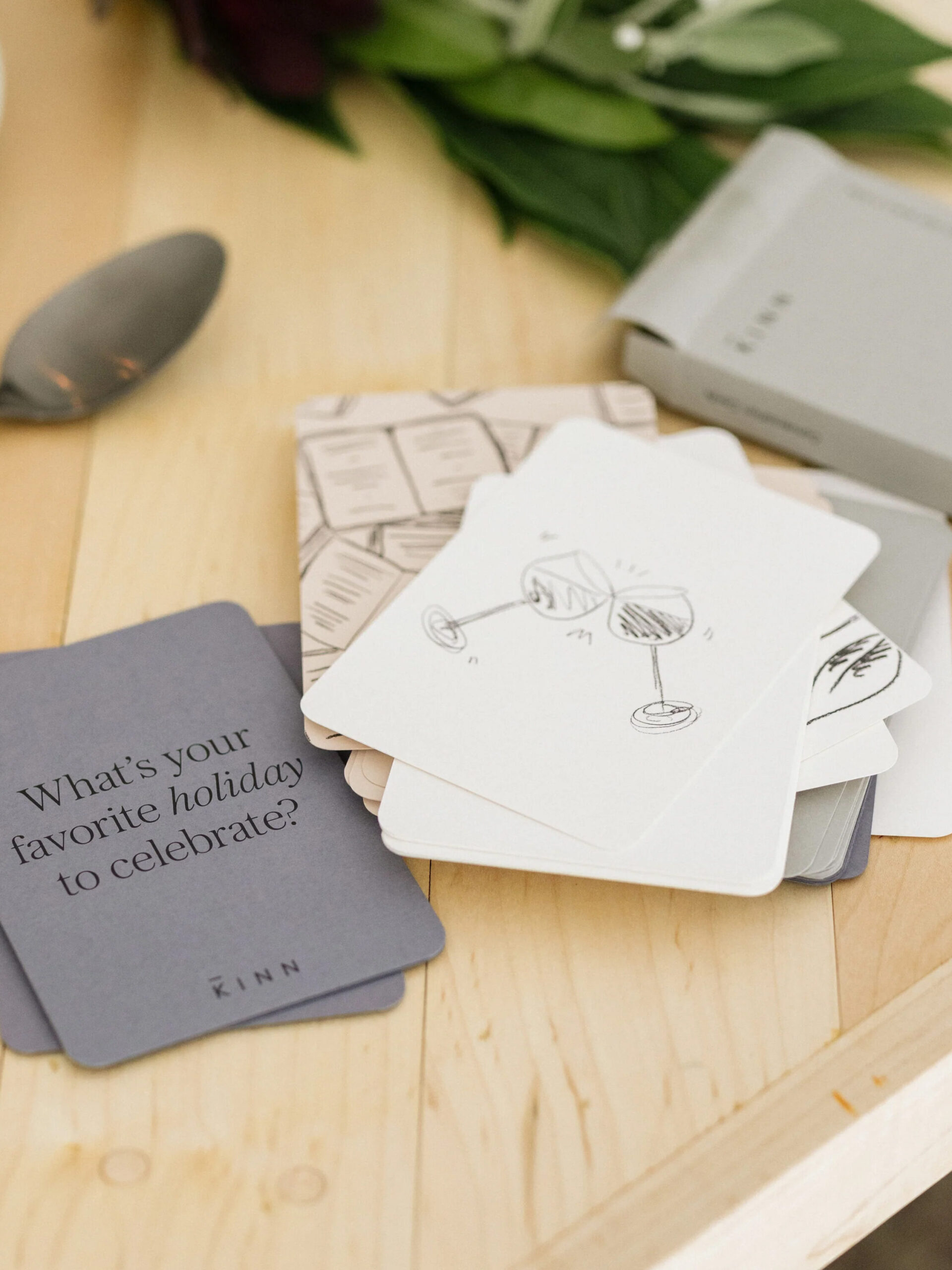 A set of cards and a spoon on a table.