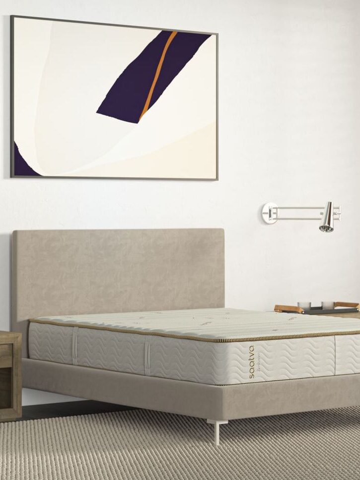 A Saatva latex mattress on a bedframe.