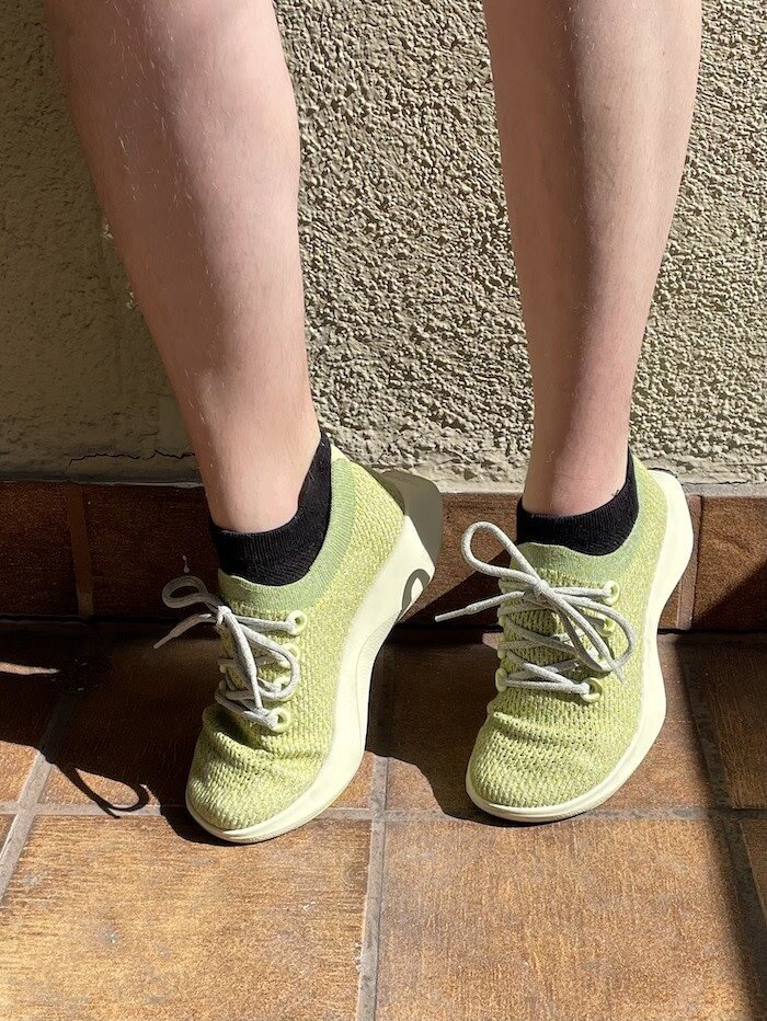 Close up shot of Allbird's Tree Dasher shoes in a highlighter green shade.