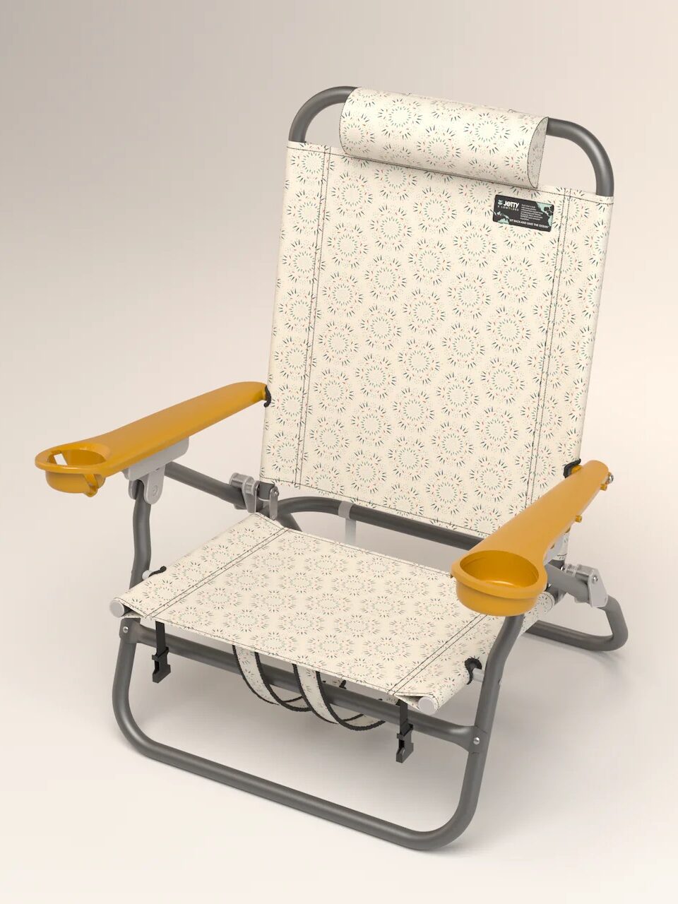 A foldable beach chair with a patterned fabric and yellow armrests, featuring built-in cup holders on each armrest. The chair has a headrest and a gray metal frame.