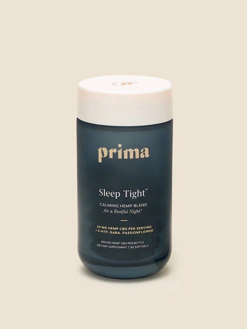 A container of Prima's Sleep Tight calming hemp blend dietary supplement. The label highlights 20 mg CBD per serving mixed with herbs and amino acids. The container is dark blue with a white lid.