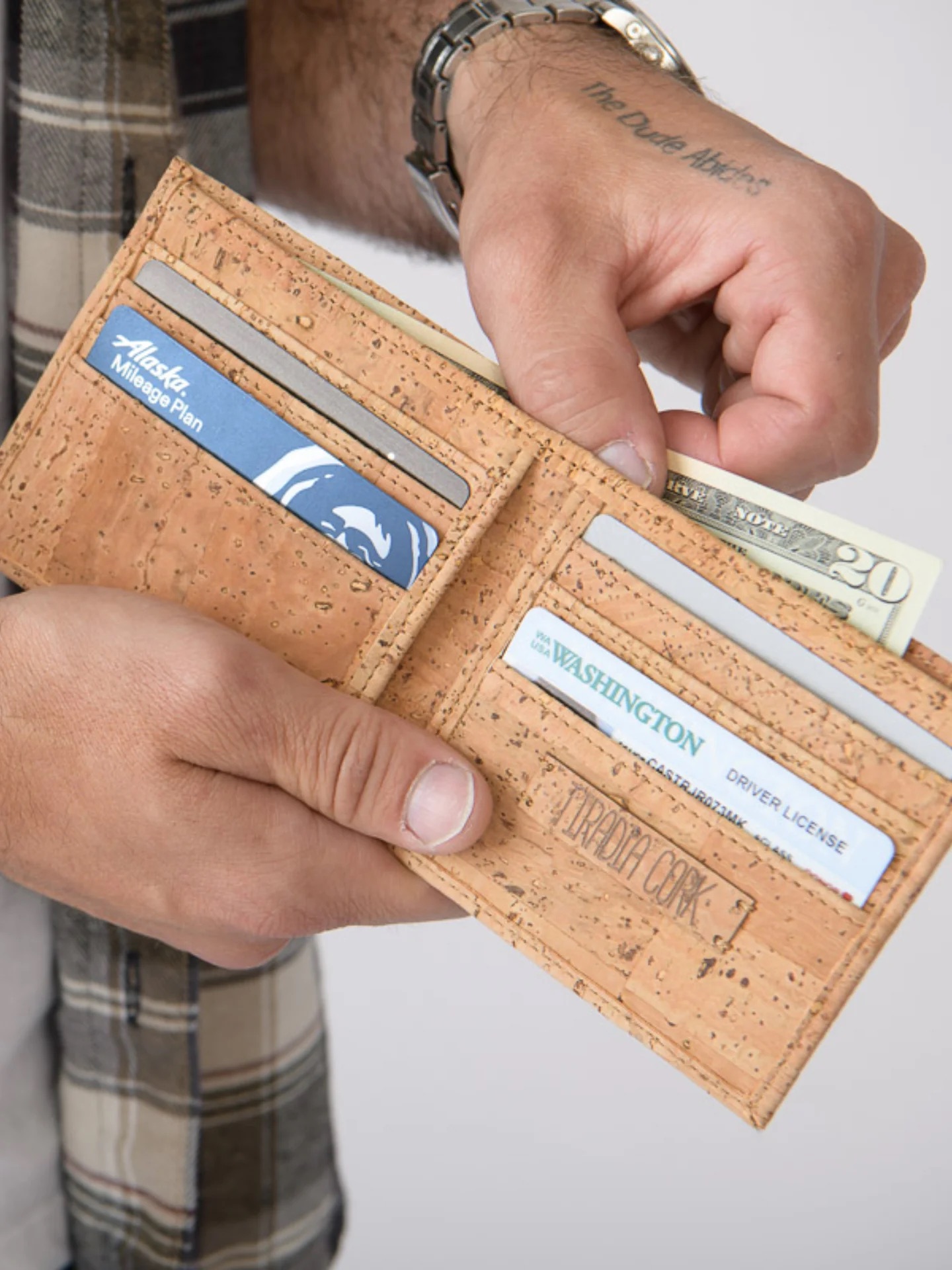 a model pulling out cash from a Tiradia wallet.