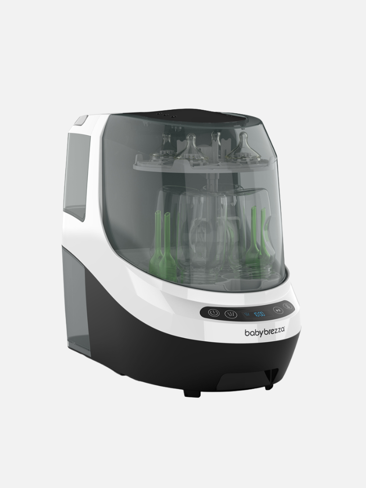 A black and white Baby Brezza bottle sterilizer and dryer with multiple baby bottles and accessories inside, displayed on a plain background.