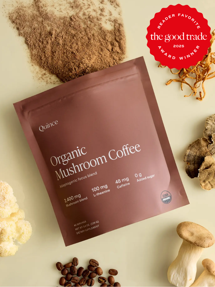 A brown package labeled "Quince Organic Mushroom Coffee" surrounded by coffee beans, mushrooms, and a red "The Good Trade 2025" award badge.