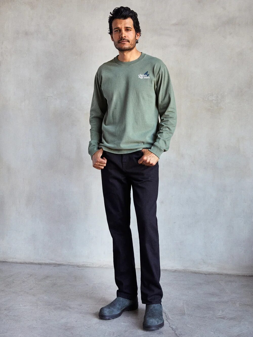 A model wearing black Outerknown jeans.