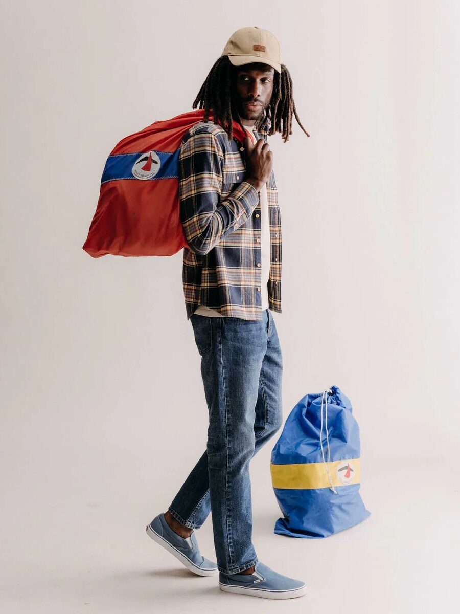 A model wearing medium wash Taylor Stitch jeans.