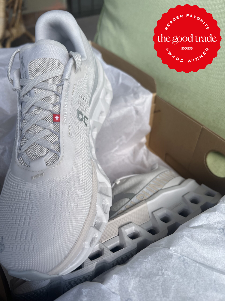 White athletic shoes with textured soles in an open cardboard box. A red badge in the corner reads, "Reader Favorite, The Good Trade Award Winner 2025.